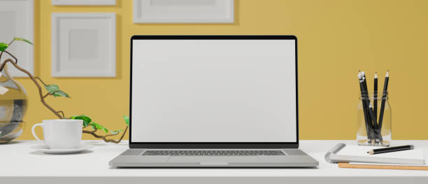 istock Computer laptop with mock-up screen on the table with stationery in home office room, 3D rendering 1322443404