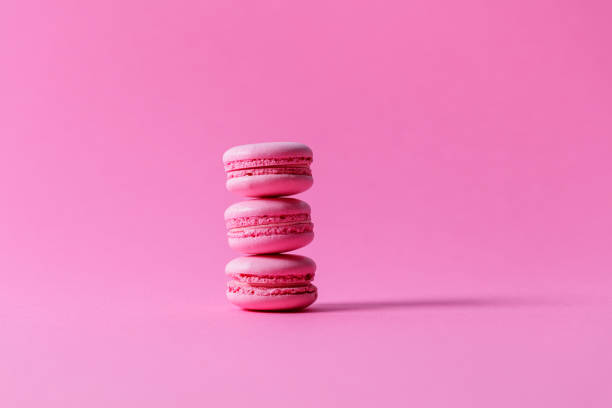 istock Pink macaroons with pink filling stacked on pink background 1322445332