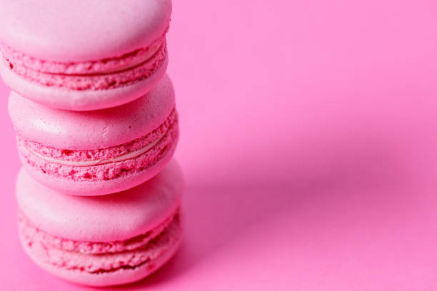 istock Close-up on stack of pink macaroons with pink filling on pink background 1322445342