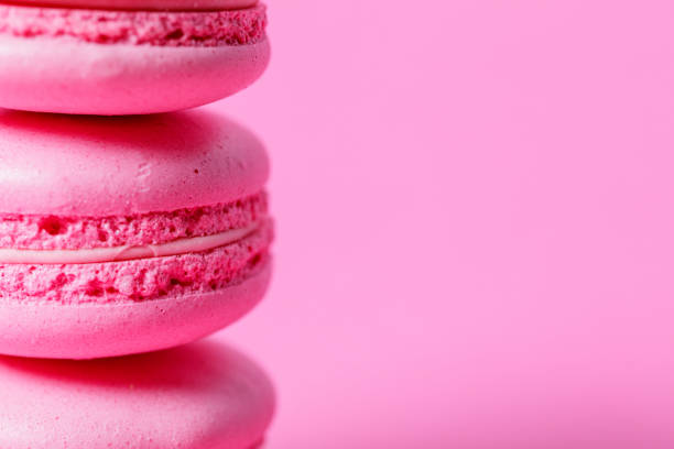 istock Close-up on stack of pink macaroons with pink filling, pink background 1322445354