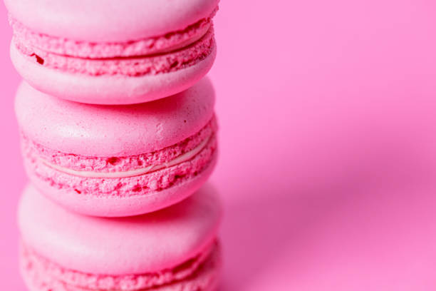 istock Close-up on stack of pink macaroons with pink filling on pink background 1322445360