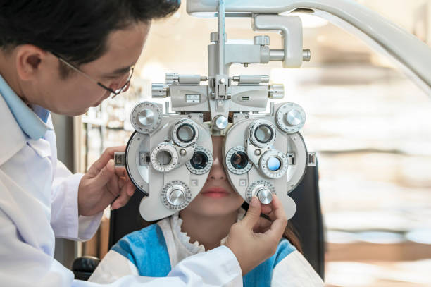 istock Children are tested with ophthalmology equipment by an optician. 1322445403