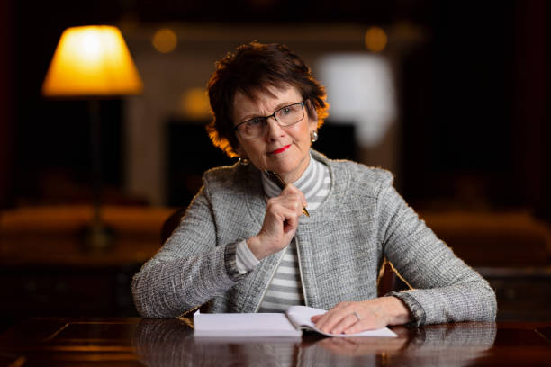 istock Woman sitting at a desk thinking what to write 1322449183