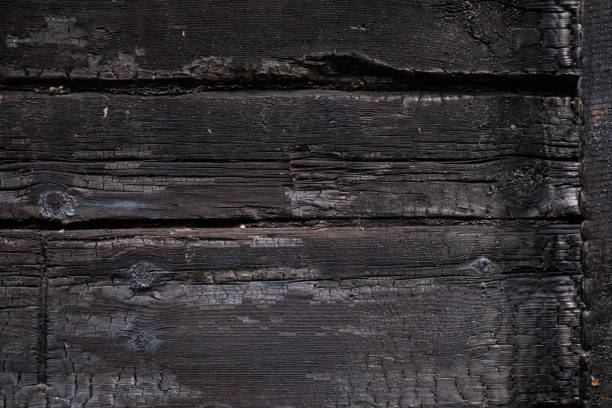 istock Burnt wooden Board texture. Burned scratched hardwood surface. Charred board 1322450278
