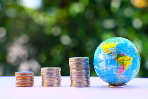 istock Saving money concept and stacking coins on table on green bokeh background, business growth concept, finance and investment concept, Advertising coins of finance and banking 1322454836