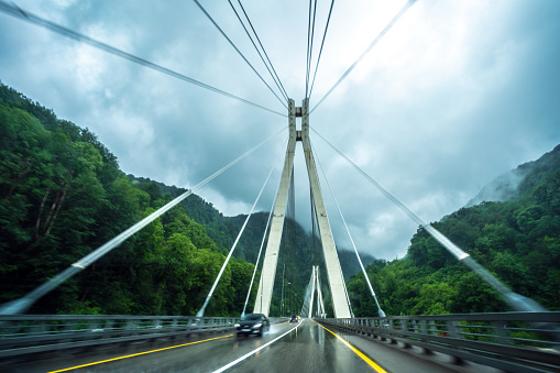 Driving across a bridge under an overcast sky