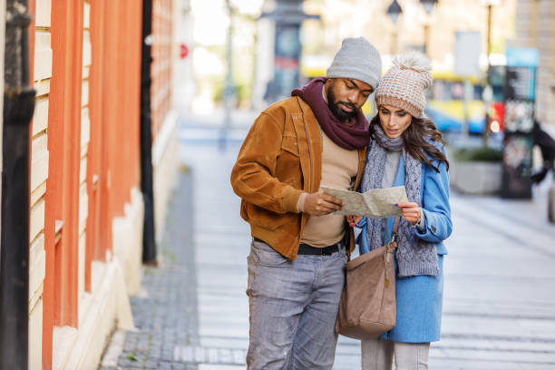 istock Happy Multi-Ethnic Couple is Walking in the Streets and Exploring the City Using a Map. 1322456229