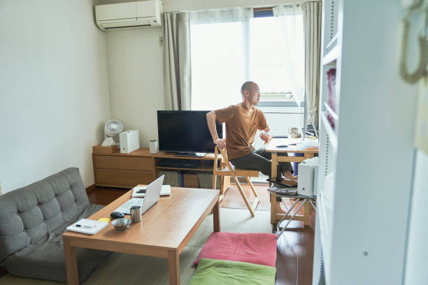istock Mid adult japanese man working from home. 1322458328