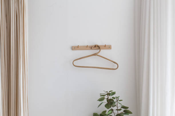 istock one wooden hangers on a white wall. 1322459125