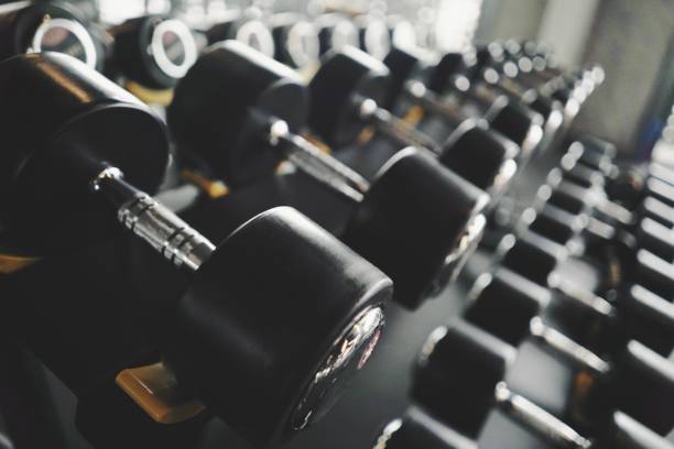 istock Dumbells in the gym center 1322460980