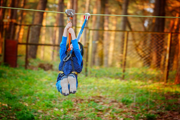 istock adorable cheerful little boy ziplining in the forest 1322461342