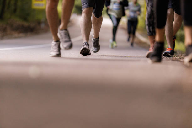 istock Unrecognizable athletes running a marathon on the road. 1322462266