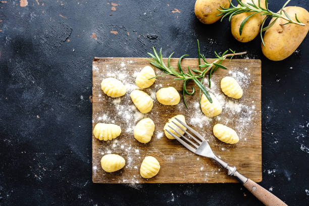 istock Raw homemade gnocchi on a rustic wooden cutting board 1322464513