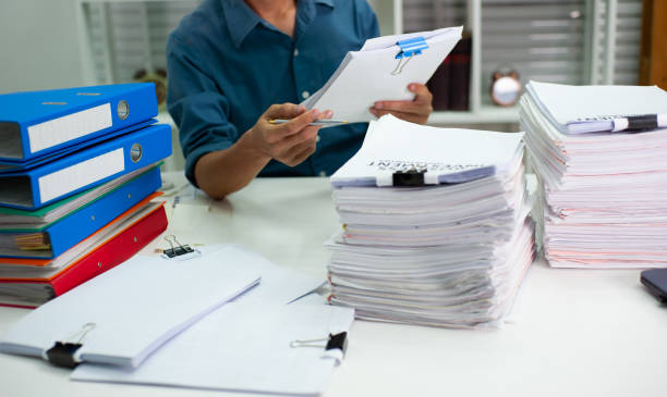 The auditors are busy working in the office. The auditors are busy working in the office. banking document stock pictures, royalty-free photos & images