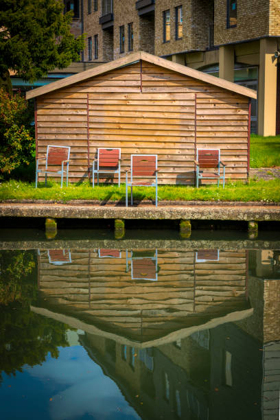 A retro style image of a boathouse and chairs in Cambridge