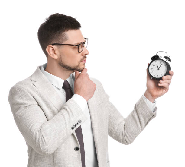 istock Businessman holding alarm clock on white background. Time management 1322466525