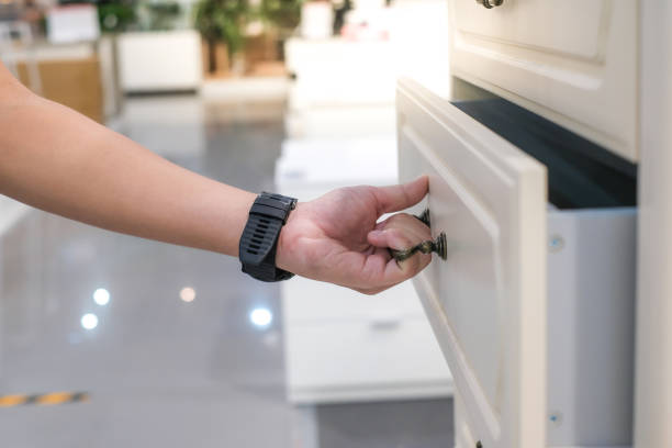 istock man open shelf, pull open drawer wooden in cabinet. 1322468400