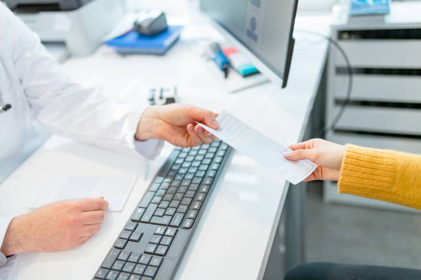 istock Passing prescription to patient over the desk 1322468664