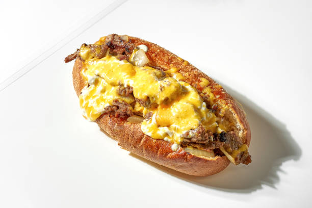 istock Classic cheese steak with beef, onion, cheddar cheese and mozzarella. White background. Hard light 1322469905