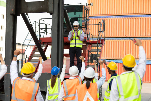 istock warehouse boss engineer standing on crane car with factory workers clapping hands for congratulations work in containers warehouse storage 1322471293