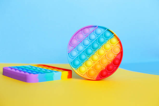 istock modern trendy silicone toy pop on a multicolored background. children's educational antistress toy 1322471526
