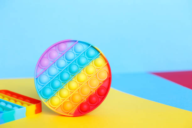 istock modern trendy silicone toy pop on a multicolored background. children's educational antistress toy 1322471539
