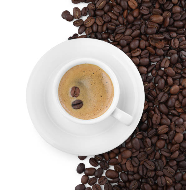 istock Cup with aromatic coffee and pile of beans on white background, top view 1322472450
