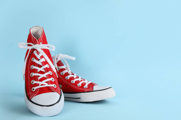 istock Pair of stylish sneakers on light blue background, space for text 1322472827