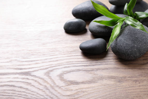 istock Spa stones and bamboo sprout on wooden table, space for text 1322472987