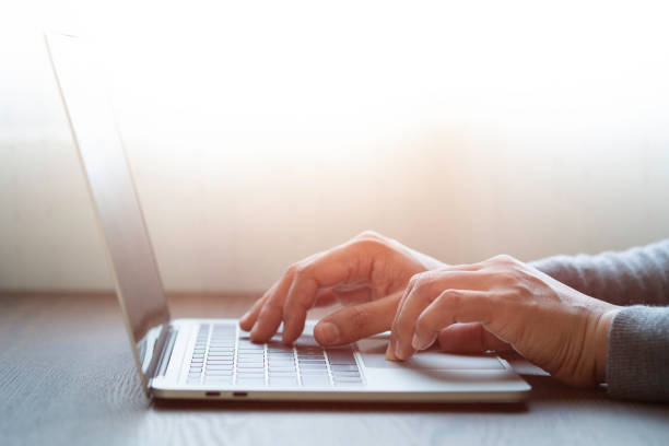 istock Close-up of man hands using and typing keyboard of laptop computer on office desk. Workspace, businessman working project creative idea for job online network. Business finance and technology concept. 1322474009