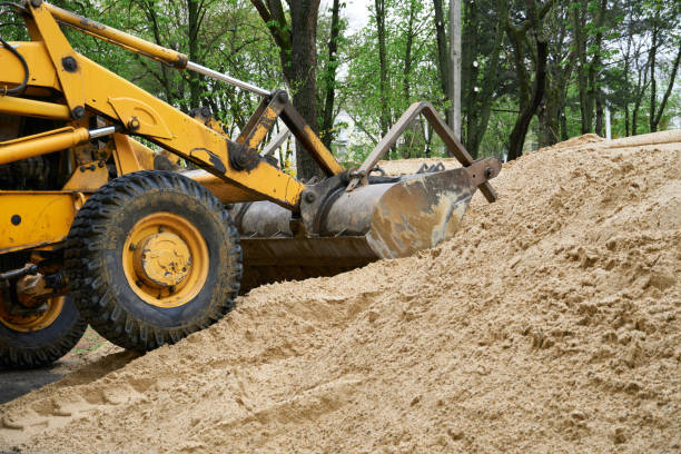 istock tractor or bulldozer works with a pile of sand for construction 1322477141