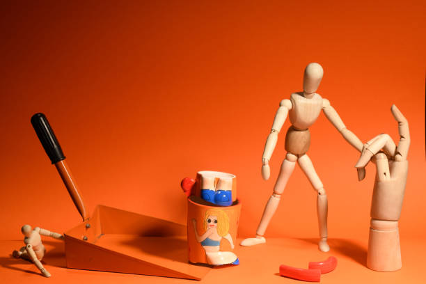 istock wooden man  posing in a orange background 1322478449