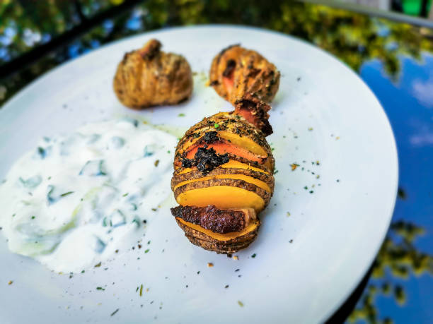 istock Hasselback potatoes with cucumber salad 1322478665