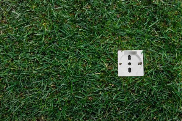 Green grass and green energy - Socket in green grass