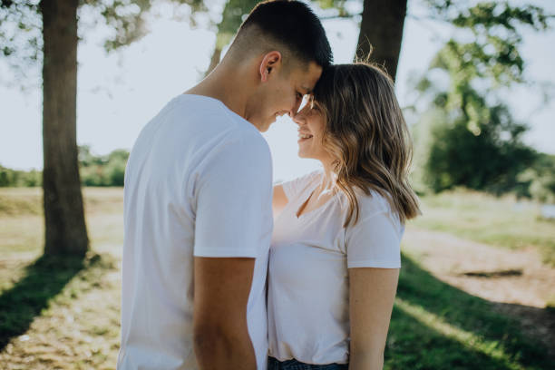 istock Lovely couple in meadow enjoy the sunset 1322478871