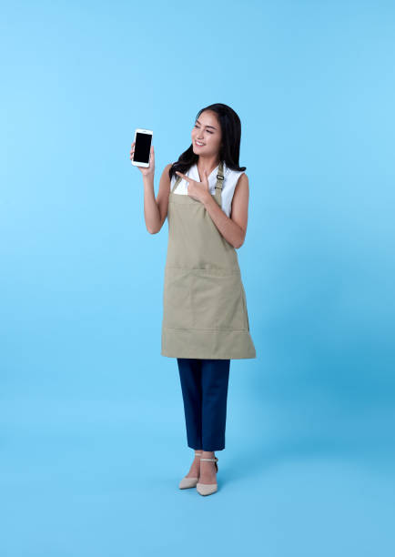 istock Entrepreneur asian woman using smartphone on blue background. 1322481704