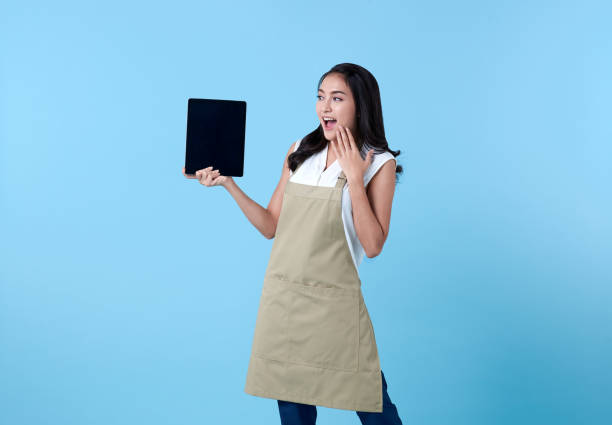 istock Entrepreneur asian woman using tablet computer on blue background. 1322481705