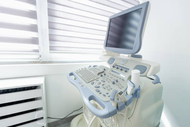 Modern ultrasound equipment with control panel and monitor in empty examination room in medical clinic
