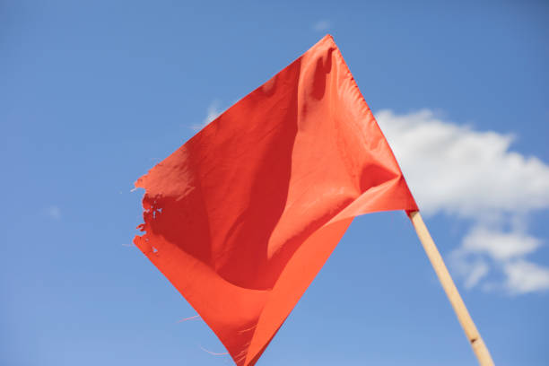 istock Red flag against the sky. Red matter on a stick. 1322485363