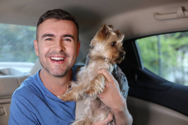 istock Man riding in backseat with his furry friend 1322485568