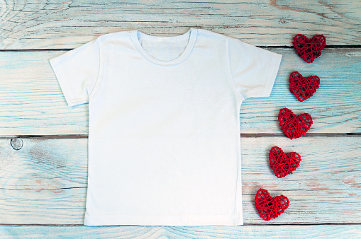 Blank white t-shirt with heart decor, unisex valentine's day apparel mock up. Stock photo