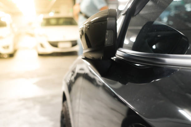 istock Modern prestigious car close up. Car window and rearview mirror, side doors. 1322491205