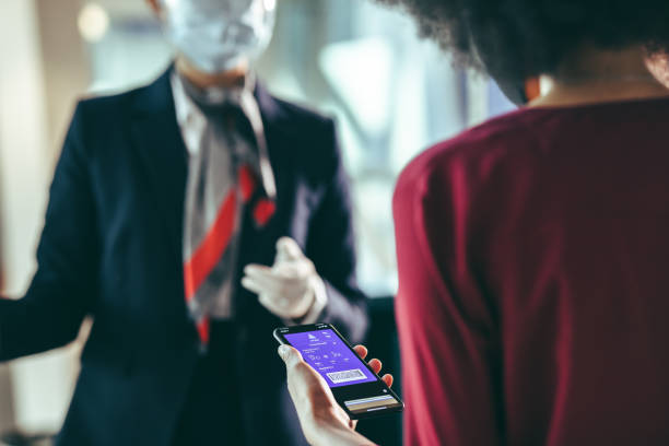 istock Woman checking in at airport terminal using mobile phone 1322491549