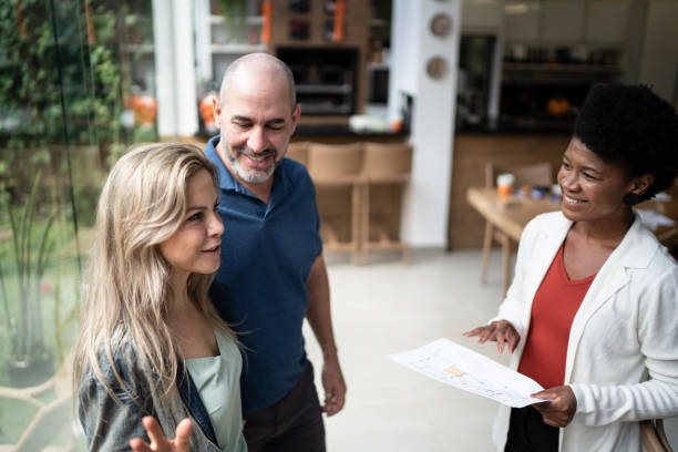 istock Real estage agent showing house to a couple 1322491776