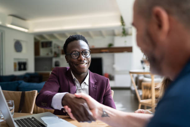 istock Real estate shaking hands with customer setting a deal at home 1322491777