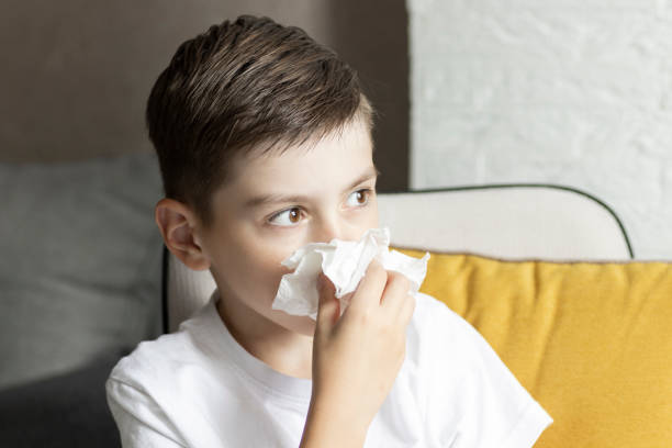 istock A father on paternity leave looking after small son indoors, blowing his nose. 1322491790