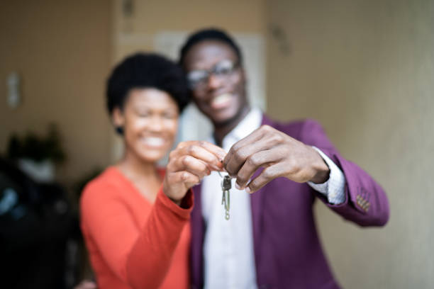 istock Couple showing new house key 1322491863