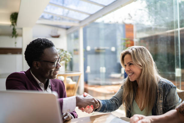 istock Real estate shaking hands with customer setting a deal at home 1322491868