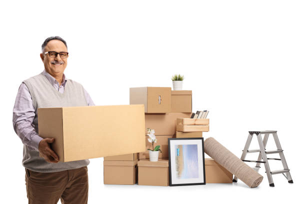istock Smiling mature man packing for home removal and holding a cardboard box 1322492901