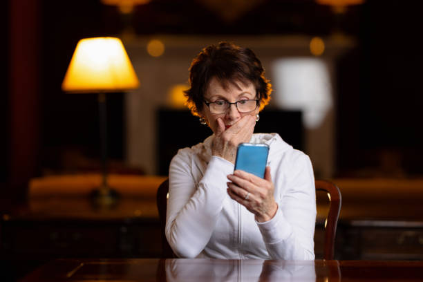 istock Woman looking at her phone with a shocked expression 1322493030